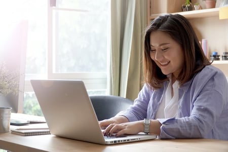 person using a laptop to browse for joomla alternatives