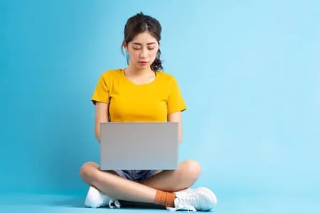 woman looking at blue website designs against blue background